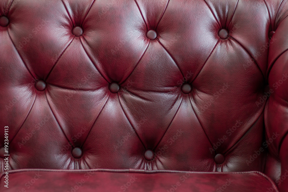 Fototapeta premium Closeup texture of vintage red leather sofa for background