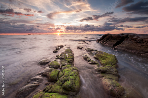 colorful sunset sky with rocks covered by green moss at Kudat Sabah Malaysia.