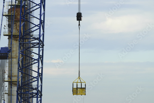 ower cranes build large residential buildings at construction site .