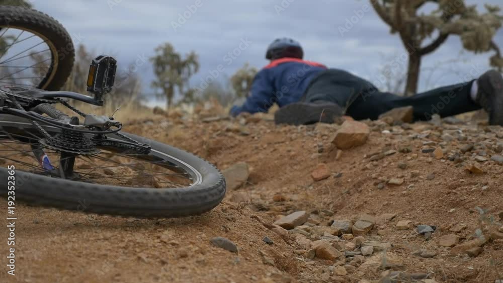 Mountain biker gets up after a fall