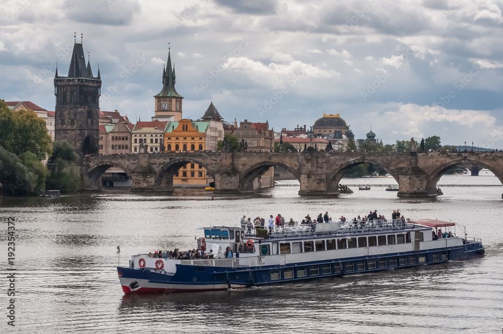 Tourist ship on the background of Charles Bridge Tourist ship on the background of Charles Bridge