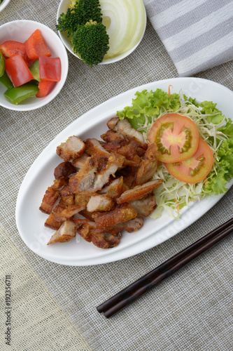 Deep fried pork belly with fish sauce on the table.