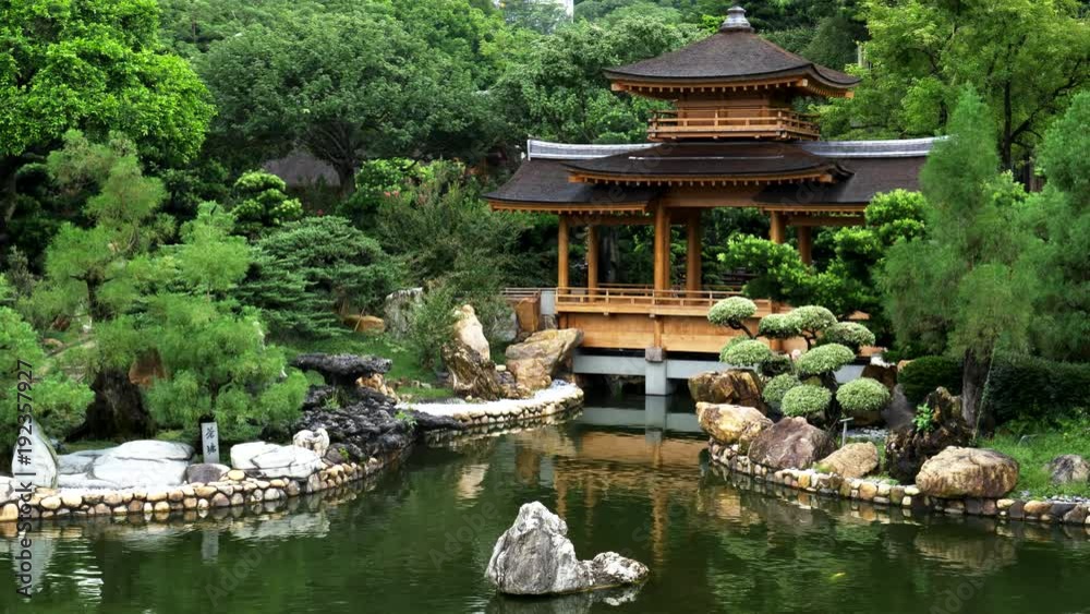 the blue pond and pavilion bridge at nan lian gardens in hong kong, china the blue pond and pavilion bridge at nan lian gardens in hong kong, china