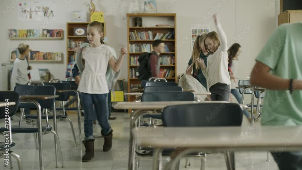 Panning shot of children arriving for start of class in elementary school / Provo, Utah, United States