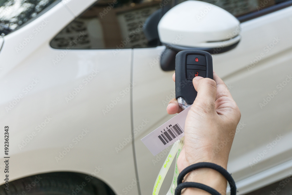 Women hand presses on the remote control car alarm systems. secure concept. safety concept. steal concept. transport concept. Women hand presses on the remote control car alarm systems. secure concept. safety concept. steal concept. transport concept.