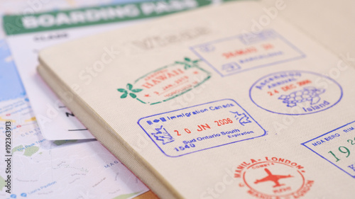 Passport page with border stamps and map with boarding pass background