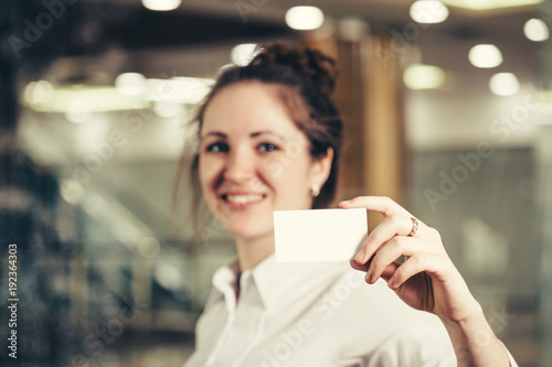 Beautiful girl with a business card.