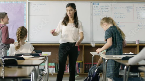 Frustrated teacher scolding children in chaotic classroom / Provo, Utah, United States