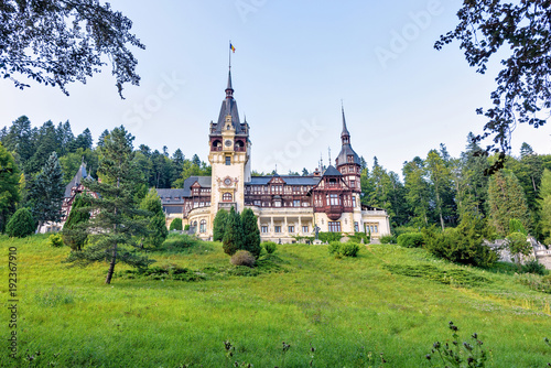 Daylight far view to Peles castle front facade with hanging flag