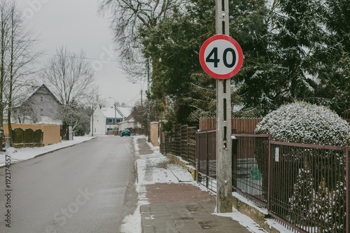 Speed limit sign. Slippery snowy winter road 40 kmph limit neighbourhood. photo