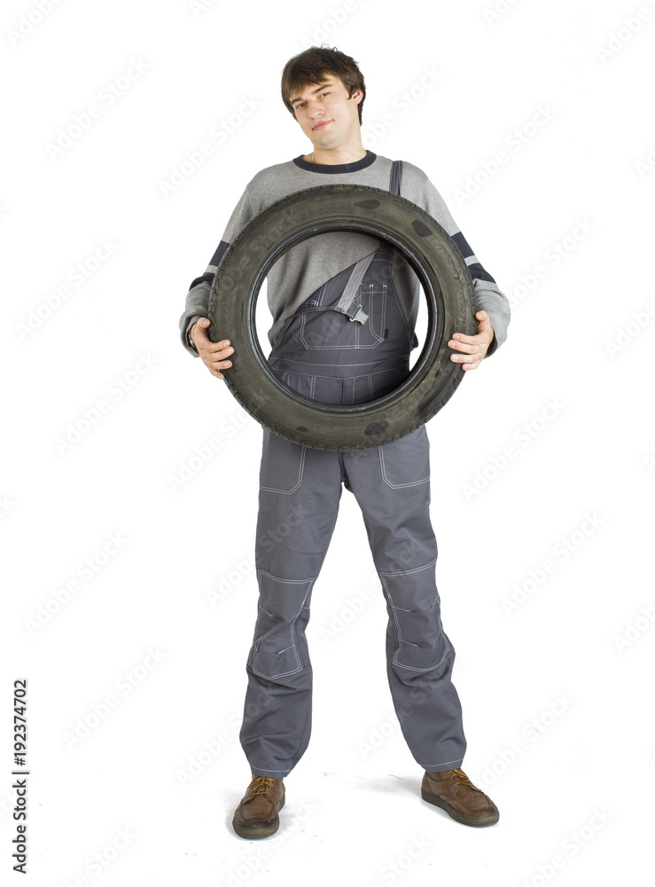 A young brunet foreman in working grey uniform with black wheel. A young brunet foreman in working grey uniform with black wheel.