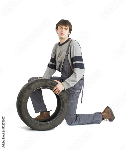 A young brunet foreman in working grey uniform with black wheel.