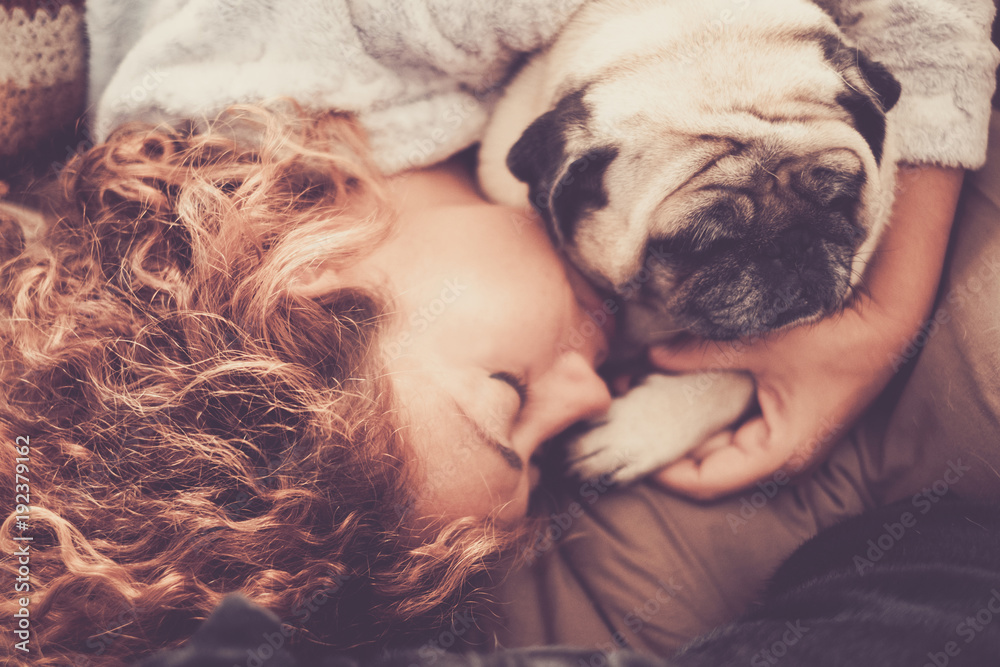 freat love relationship between woman and pug. Best friends forever concept sleeping togheter with the paw on the hand. Protection scene. freat love relationship between woman and pug. Best friends forever concept sleeping togheter with the paw on the hand. Protection scene.