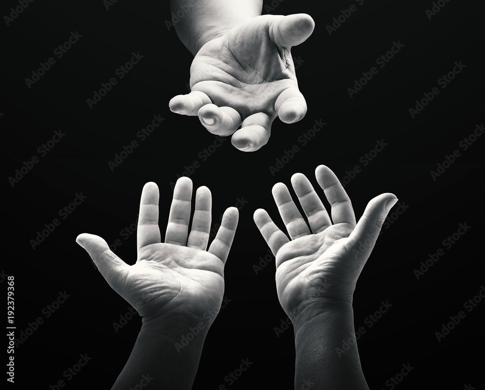 International human rights day concept: Black and white child reaching two  hand to God on dark room background Stock Photo | Adobe Stock