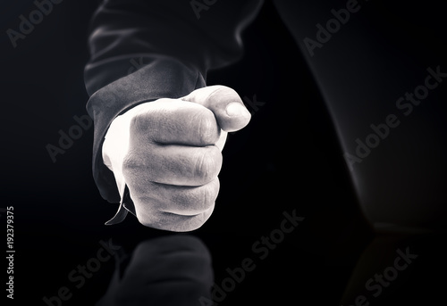 Obraz na plátně Fist hitting on black reflective table expressing power and anger