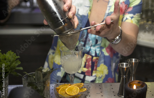 The barman is making tropical cocktails