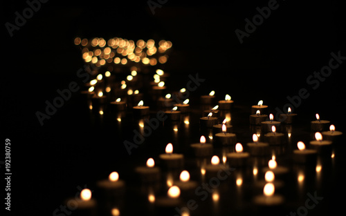 Candles light - path made of candles at night photo