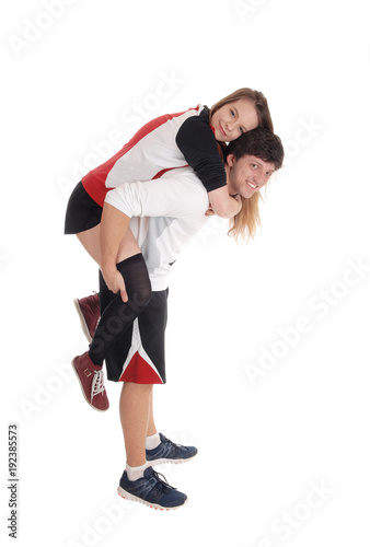 Young couple in exercise outfit do piggyback