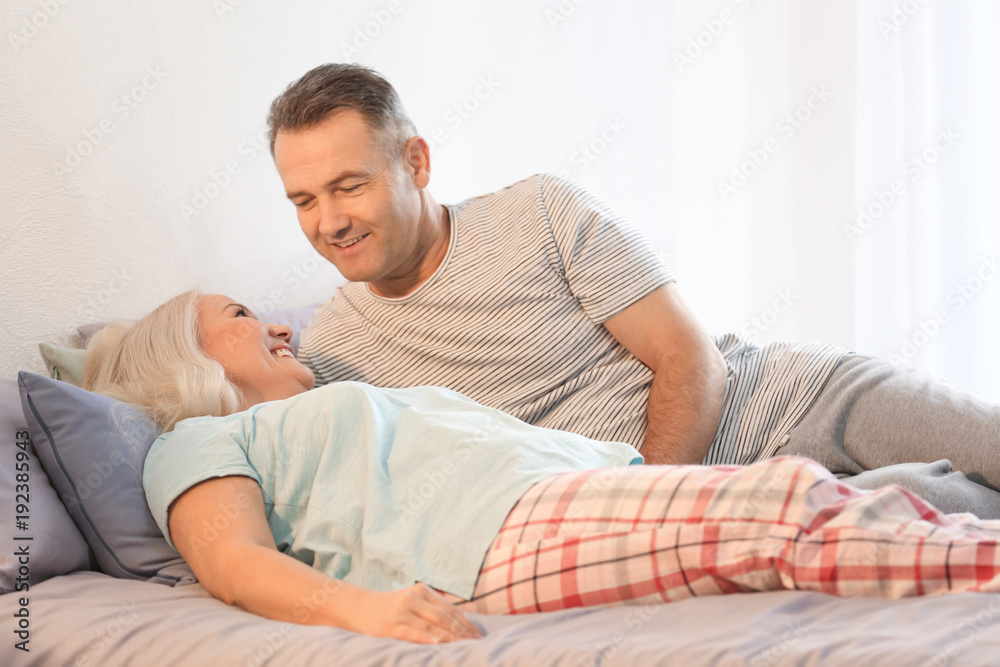 Senior couple on bed together