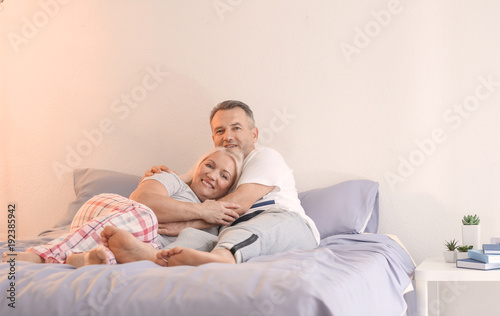 Senior couple on bed together