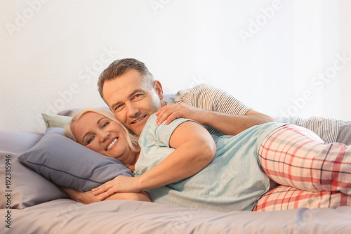 Senior couple on bed together
