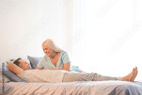 Senior couple on bed together