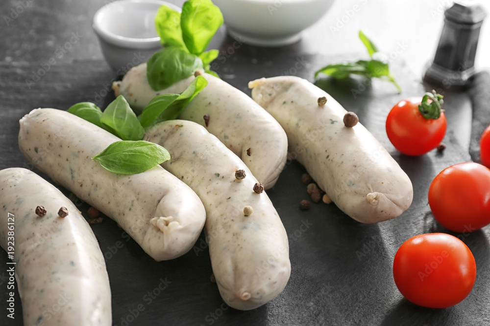 Delicious white sausages on slate plate Delicious white sausages on slate plate