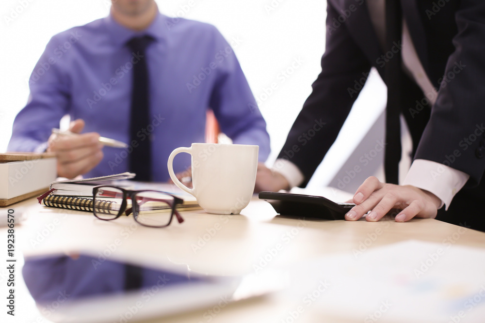 Men working at table in office, closeup. Financial trading concept Men working at table in office, closeup. Financial trading concept