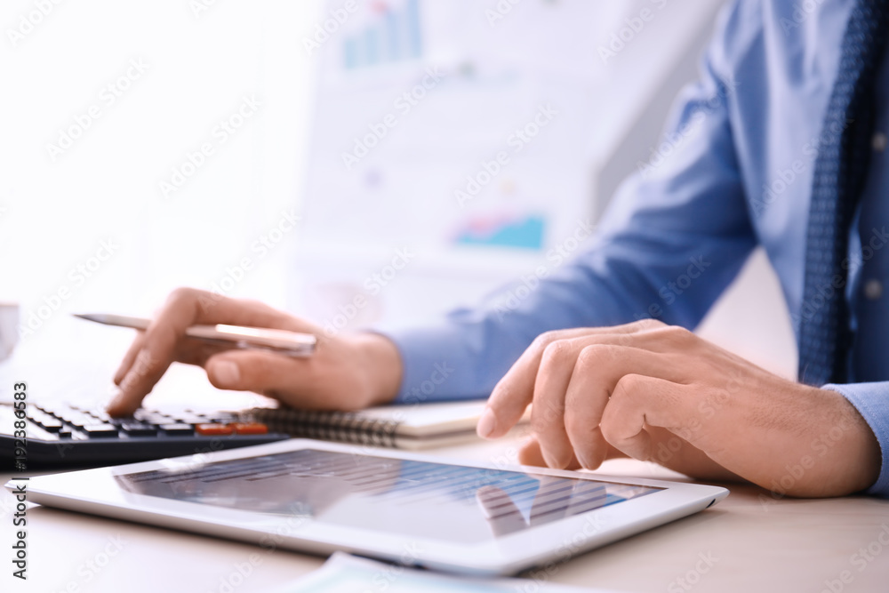 Man working at table in office, closeup. Financial trading concept Man working at table in office, closeup. Financial trading concept