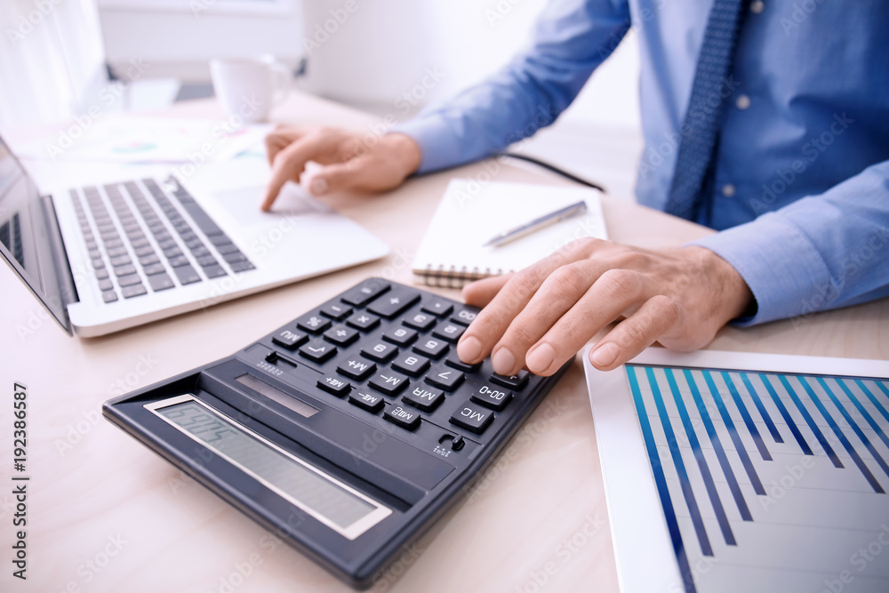 Man working at table in office, closeup. Financial trading concept Man working at table in office, closeup. Financial trading concept