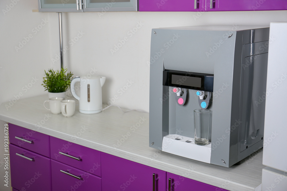 Water cooler on table indoors Water cooler on table indoors