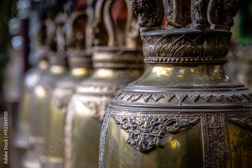 Row of Buddhist Prayer Bells Hanging in Row