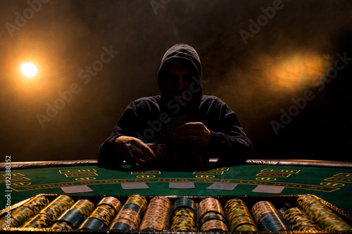 Canvas Print Portrait of a professional poker player sitting at poker table