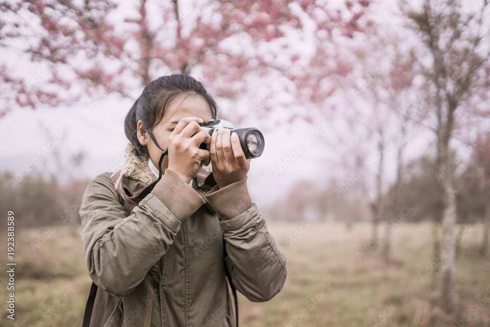 woman photographer shooting in the forest with nature beautiful background woman photographer shooting in the forest with nature beautiful background