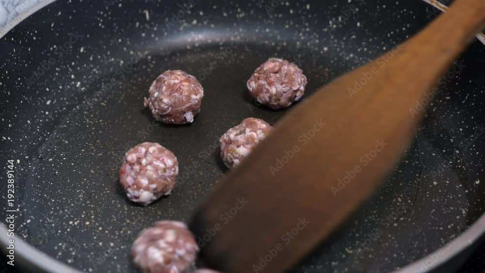 Chef stirring meatballs on pan Chef stirring meatballs on pan