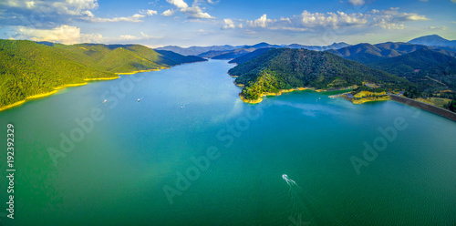 Aerial scenic panorama of beautiful lake and green hills