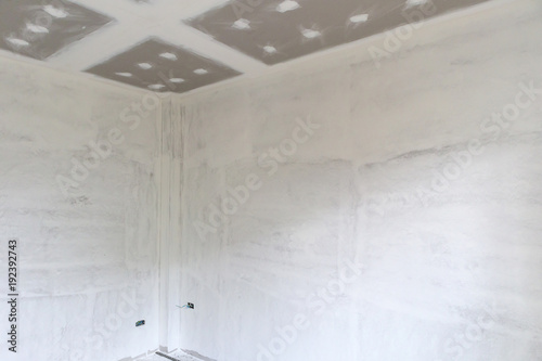 Empty room interior with gypsum board ceiling at construction site