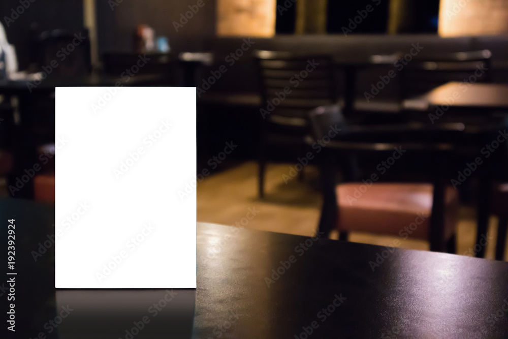 Mockup white label menu frame on table with cafe restaurant interior background Mockup white label menu frame on table with cafe restaurant interior background