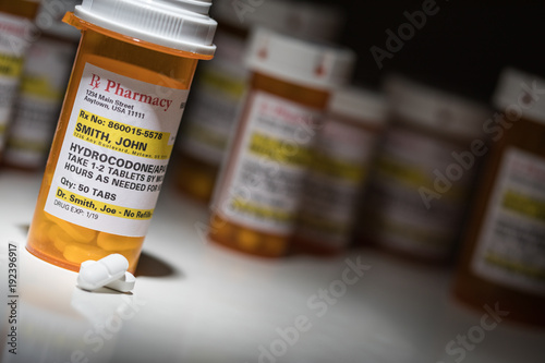 Hydrocodone Pills and Prescription Bottles with Non Proprietary Label. No model release required - contains ficticious information. photo