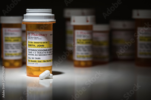 Hydrocodone Pills and Prescription Bottles with Non Proprietary Label. No model release required - contains fictitious information.