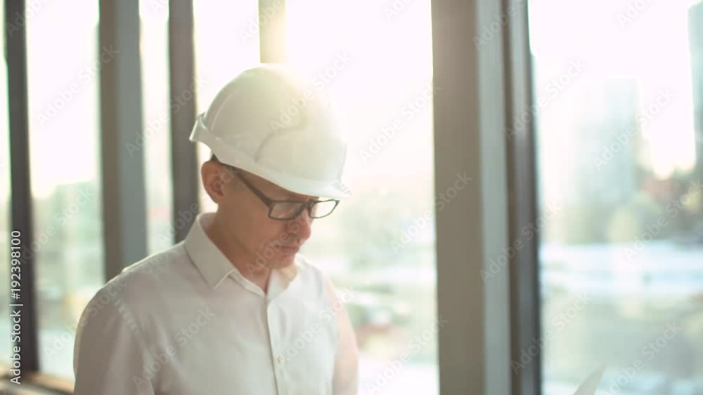 Businessman is looking at projects on a blueprint at an industrial factory. Shot on RED Cinema Camera in 4K (UHD). Businessman is looking at projects on a blueprint at an industrial factory. Shot on RED Cinema Camera in 4K (UHD).