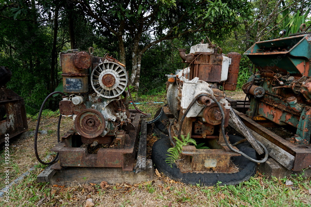 Grain Image: Close up of old machine factory made of steel and used in the past. Broken and rustic machine left over in abandon factory. Image of aged equipment with rust and gear part. Grain Image: Close up of old machine factory made of steel and used in the past. Broken and rustic machine left over in abandon factory. Image of aged equipment with rust and gear part.