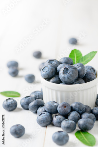 fresh blueberry fruits with leaf on white glass