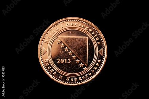 A macro image of a Bosnian 50 fenings coin isolated on a black background photo