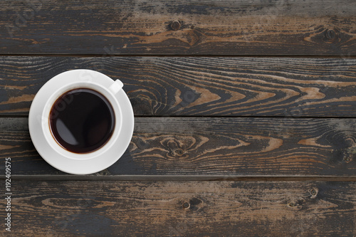 Black coffee cup on dark wooden table top view