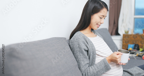 Pregnant woman drink of milk at home