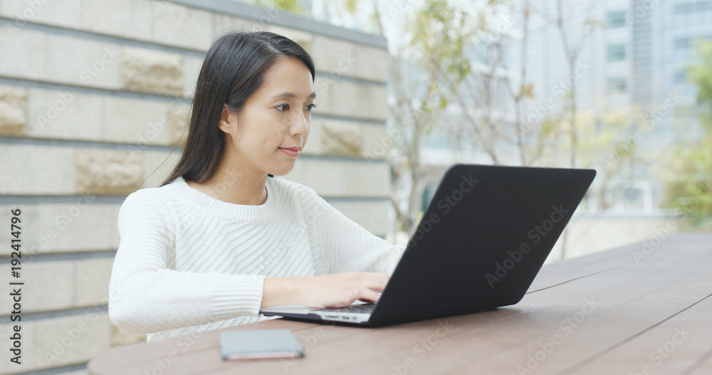 Woman working on laptop computer at outdoor Woman working on laptop computer at outdoor