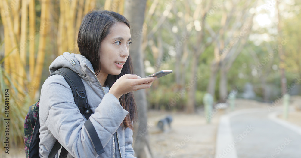 Woman sending audio message on cellphone