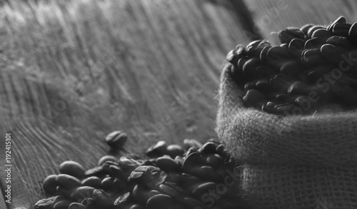 Coffee beans in sackcloth on table close up
