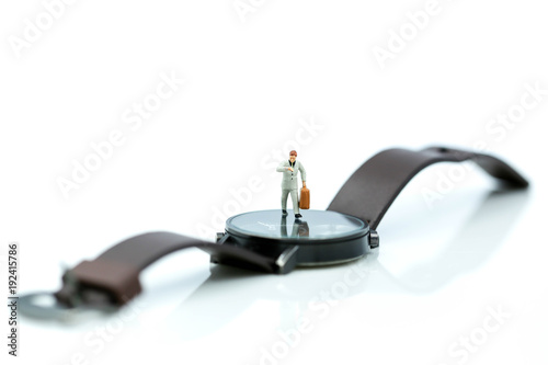 Miniature people : business man looking at watch and walk on the clock background, time business concept.